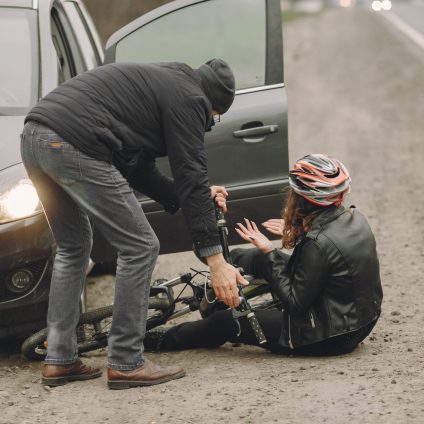 The woman crashed into the car. Girl in a helmet.